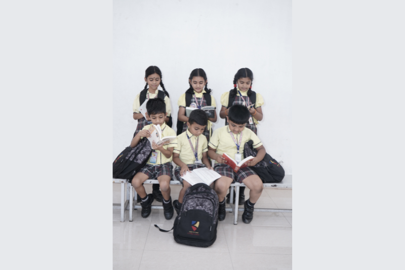 KR Public School students reading in the updated uniform